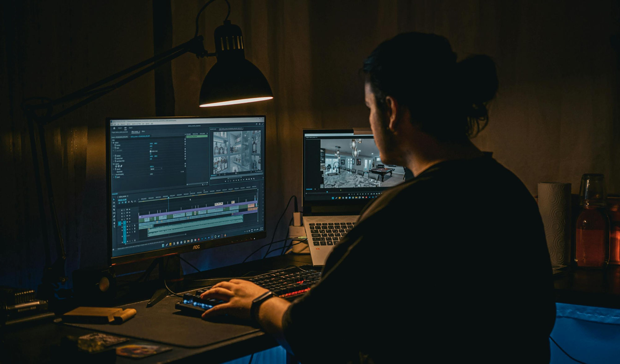 Professional video editor working at a multi-monitor cinematic workstation